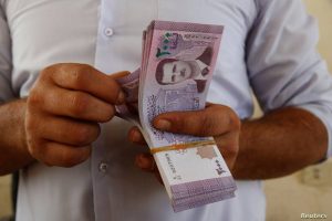 A person holding a stack of banknotes, depicting financial transactions.